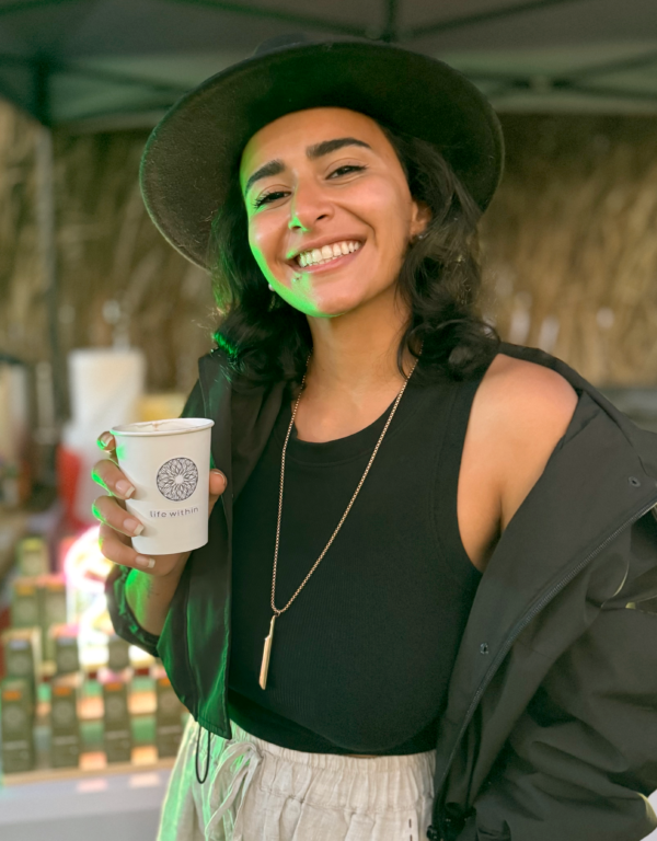 happy woman with a cup of Life Within's cacao